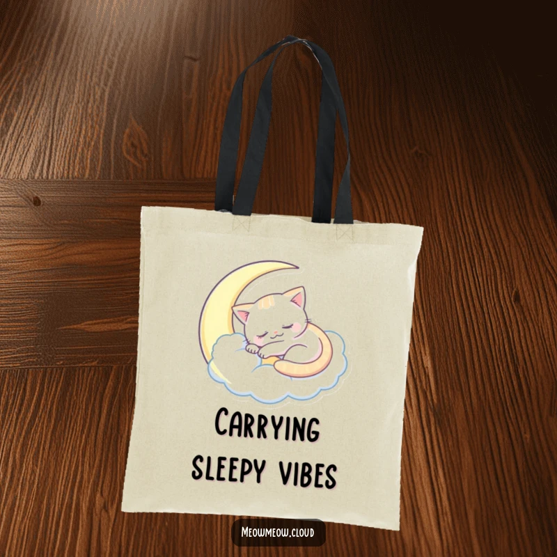Funny sleepy cat tote bag showing a cat sleeping inside a crescent moon cloud, a whimsical accessory.